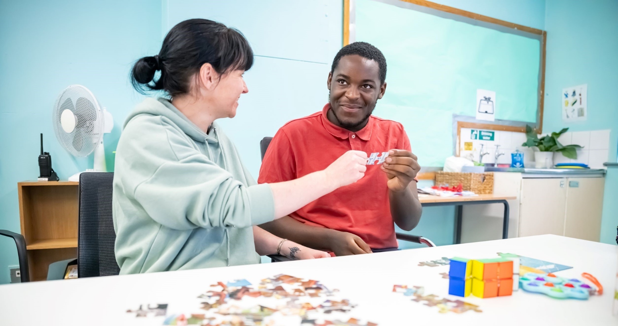 Young adults doing a puzzle together